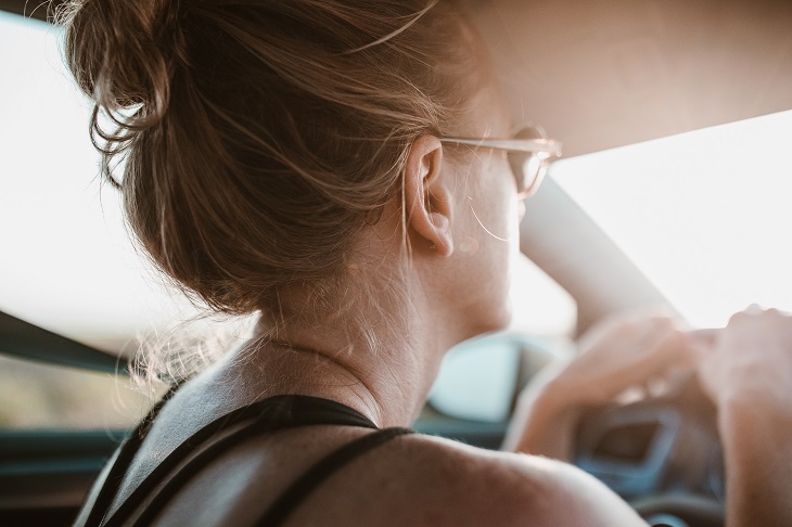 woman driving car in emotional state
