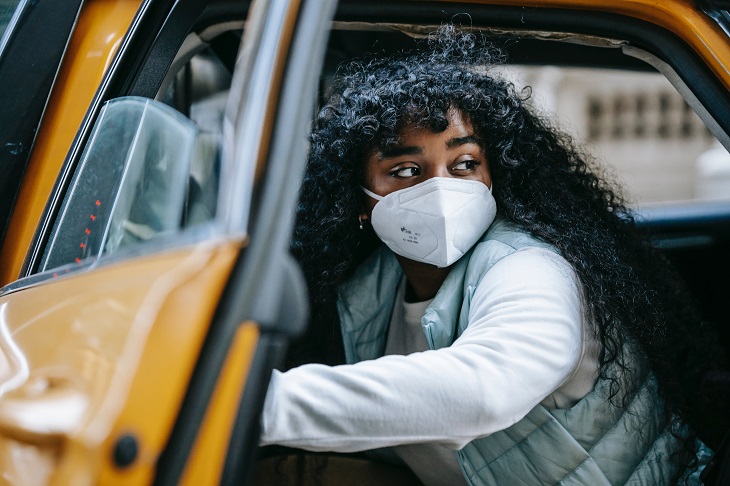 woman wearing mask while in car