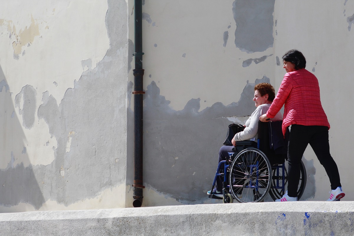 person in wheelchair with caregiver