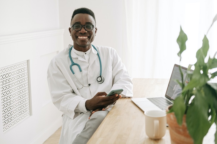 doctor with phone conducting telehealth consultation