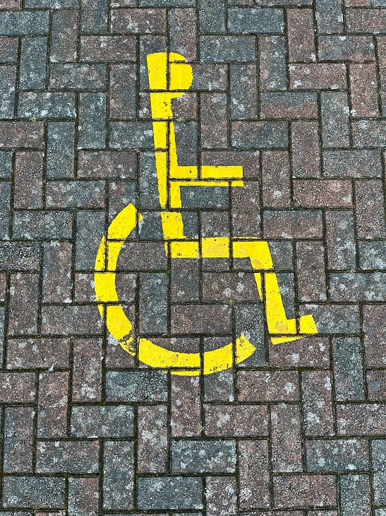 disabled parking sign painted on ground