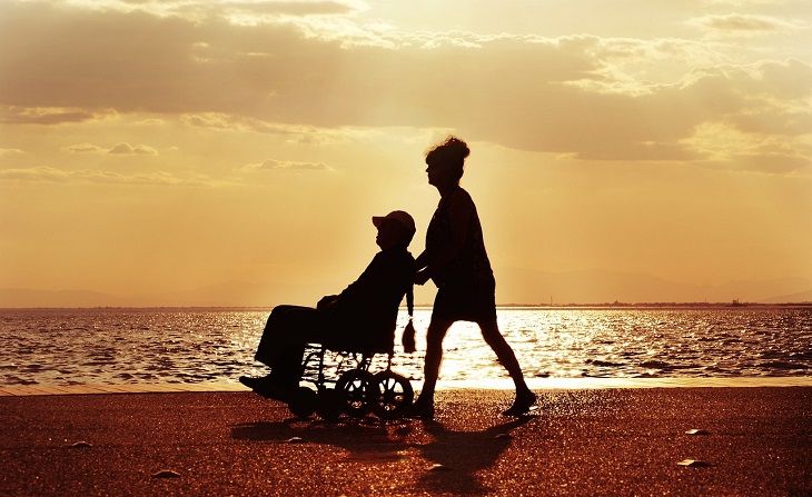person in wheelchair on beach